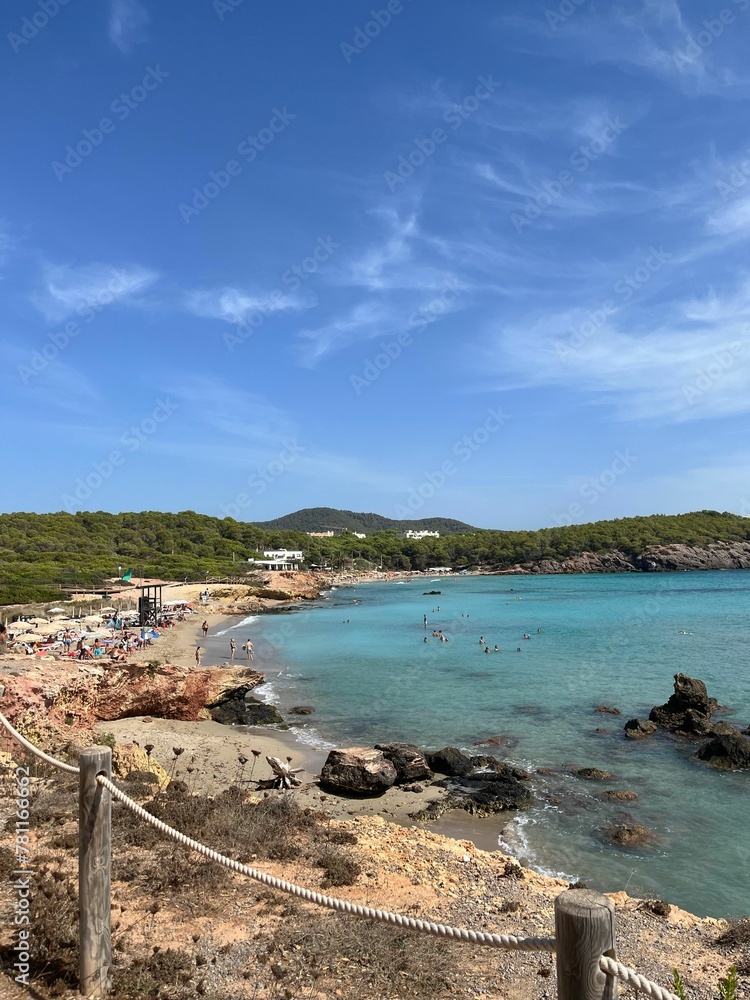 Vertical shot of a wild beach on a sunny day,  Es Canar, Ibiza