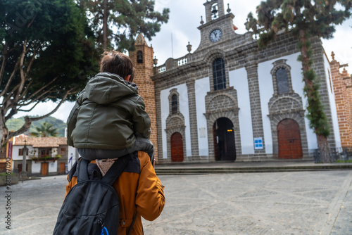 A mother with her son visiting the Basilica of Nuestra Senora del Pino in the municipality of Teror. Gran Canaria, Spain photo
