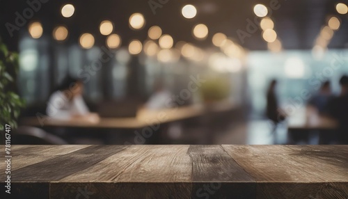 empty wood tabletop and blurred bokeh people working in office interior space banner background can used for display or montage your products photo