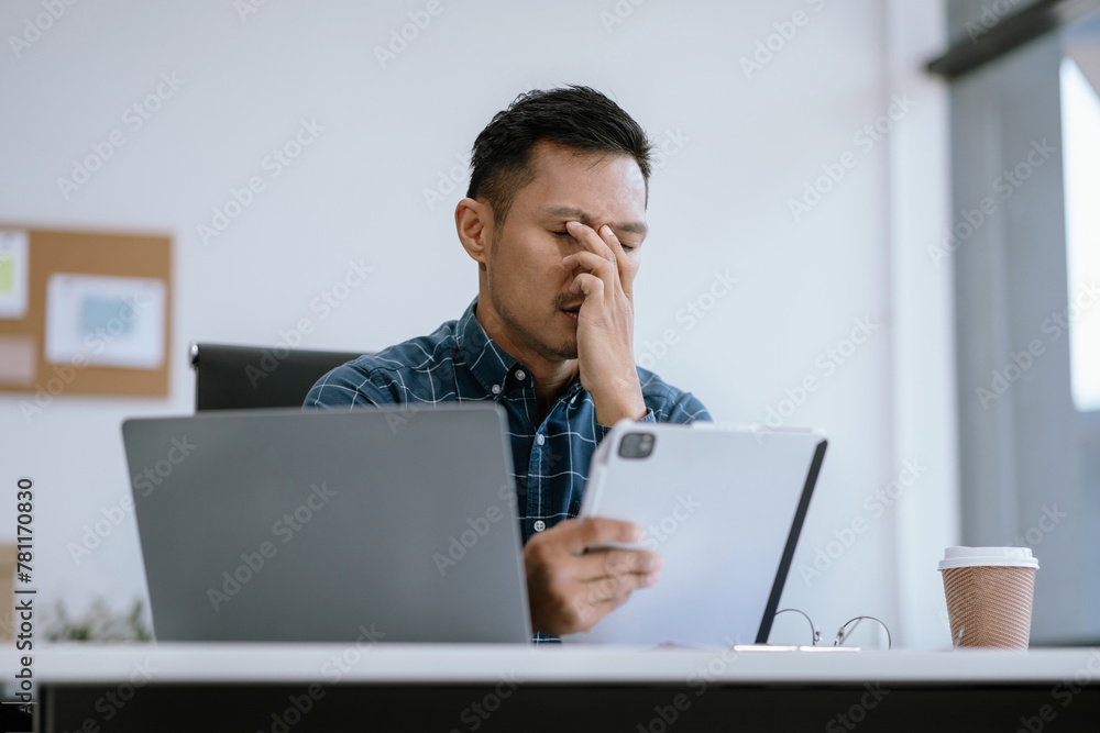 stressed asian businessman working in the office. Businessman thinking too much work concept in the office.