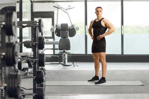 Young man posing at a gym