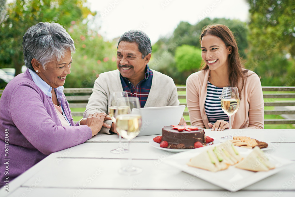 Senior, couple and romance, outdoor and tablet for celebration of anniversary of parents with champagne. Summer, relax and weekend, cake and lunch for brunch in backyard or garden, woman and family Senior, couple and romance, outdoor and tablet for celebration of anniversary of parents with champagne. Summer, relax and weekend, cake and lunch for brunch in backyard or garden, woman and family