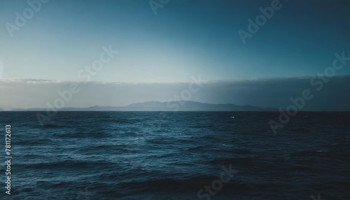 dark and blue open sea with blue sky