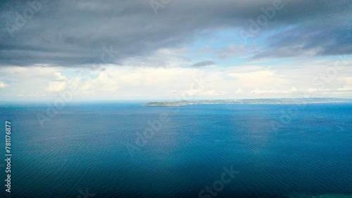 Fototapeta Naklejka Na Ścianę i Meble -  Scenic view of dark cloudy sky over clear blue endless ocean