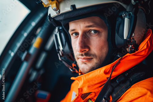 Portrait of a rescuer man in orange suit inside the rescue helicopter