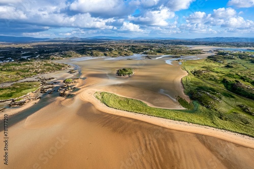 Aerial shot of the Atlantic ocean meeting the sandy shores of the County Donegal in Ireland on