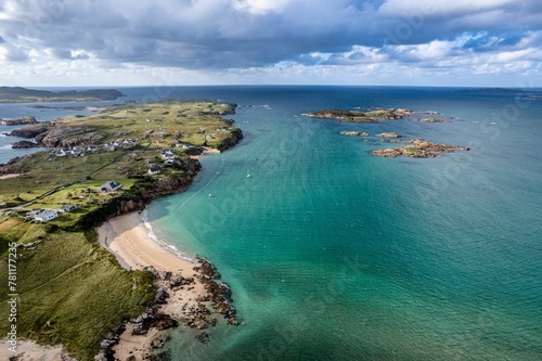 Aerial shot of the shore and the ocean in the County Donegal in Ireland on a sunny day