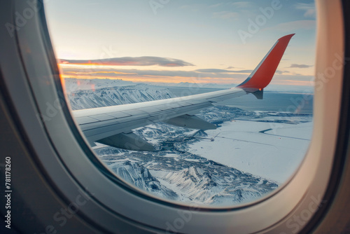 Winter landscape view with the flight wing from an airplane through window seat
