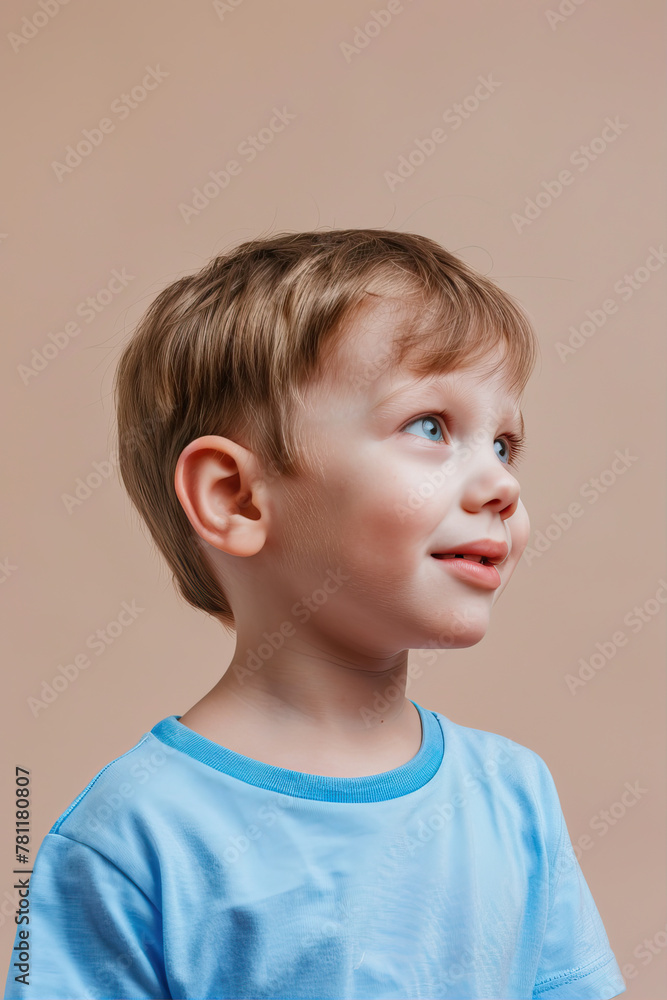 Little boy smiling on beige background
Little boy smiling on beige background