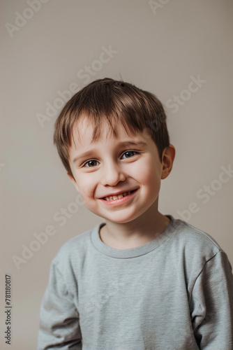 Little boy smiling on beidge background
 photo
