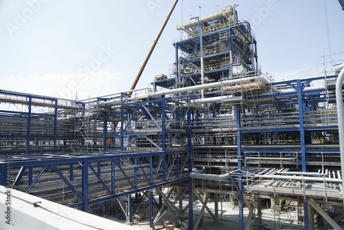 Aerial view of refinery under blue sky © Wirestock