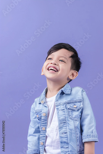 Little smiling boy on a purple background
