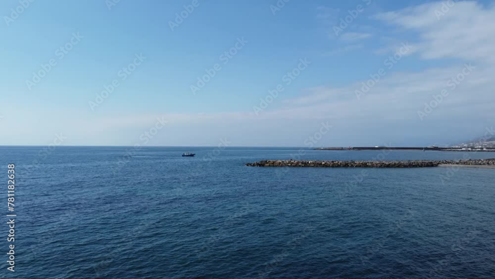 Aerial view of a fishing boat in the sea near the coast Aerial view of a fishing boat in the sea near the coast