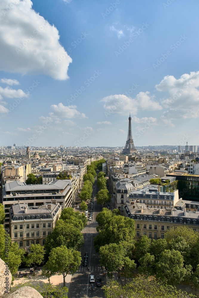 Vertical aerial shot of the city of love Paris with an Eiffel Tower in the background