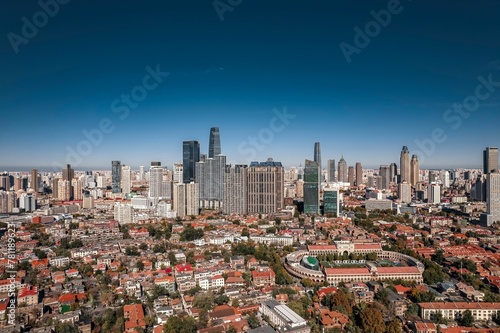 High-angle view of city full of skyscrapers under the blue sky.