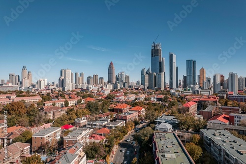 High-angle view of city full of skyscrapers under the blue sky.