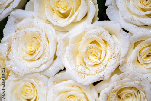 Big white roses with gold glitter, bouquet background