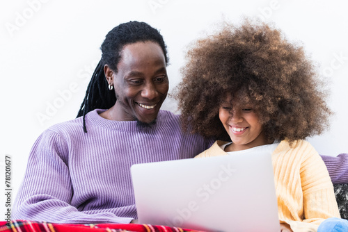 amily, fatherhood and technology concept - happy father and little daughter with pc computer at home photo