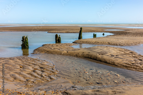 A view on Winchelsea Beach in East Sussex, with a blue sky overhead photo