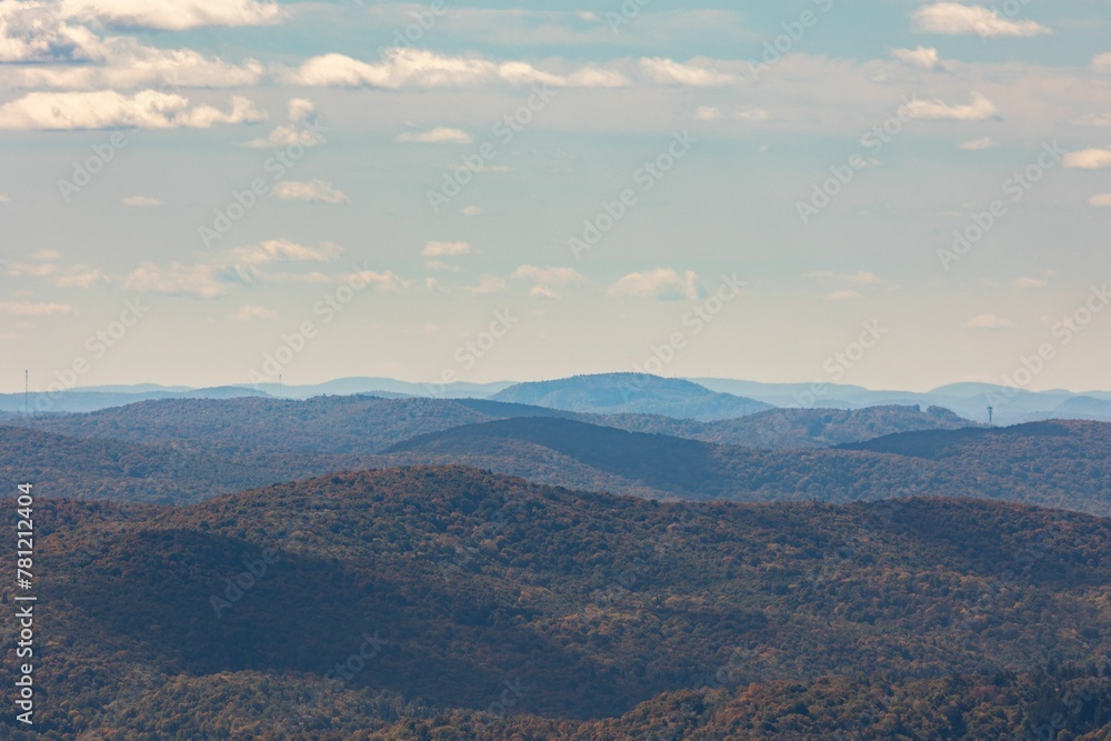 Aerial view of a vast mountain landscape under a blue sunny day