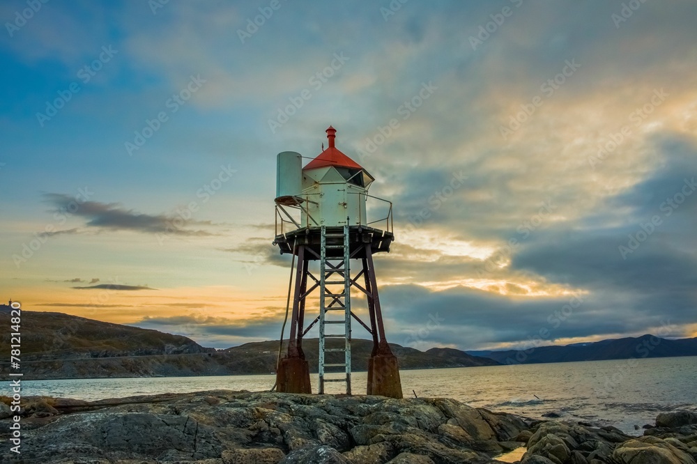 Fuglenes lighthouse in Norway, on the background of the sunrise