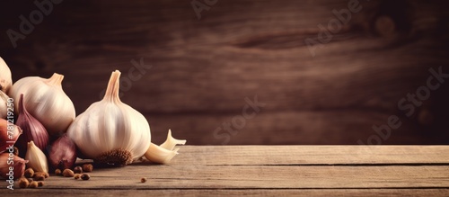 Close up of garlic bulbs and cloves on wooden surface