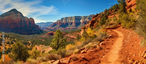 A canyon trail with mountai...