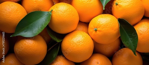 Pile of oranges with leaves...