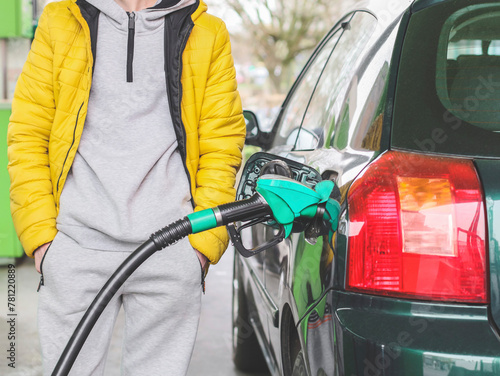 Young Caucasian man refuels the car with gasoline.