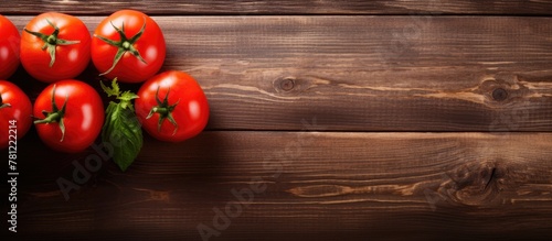 Fresh tomatoes on wooden su...