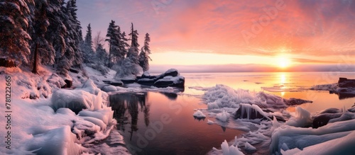 Sunrise over frozen lake with ice-covered ground © vxnaghiyev