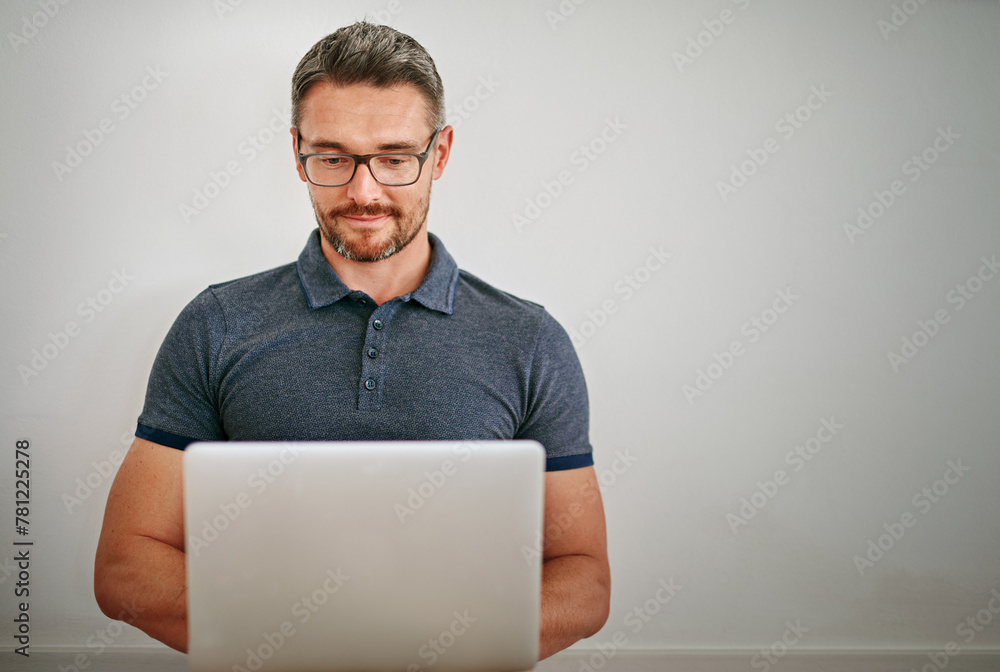 Man, wall and freelance with smile on laptop in casual for relax with social media on internet for technology. Male person, glasses and house with blog for website with typing for writer career Man, wall and freelance with smile on laptop in casual for relax with social media on internet for technology. Male person, glasses and house with blog for website with typing for writer career