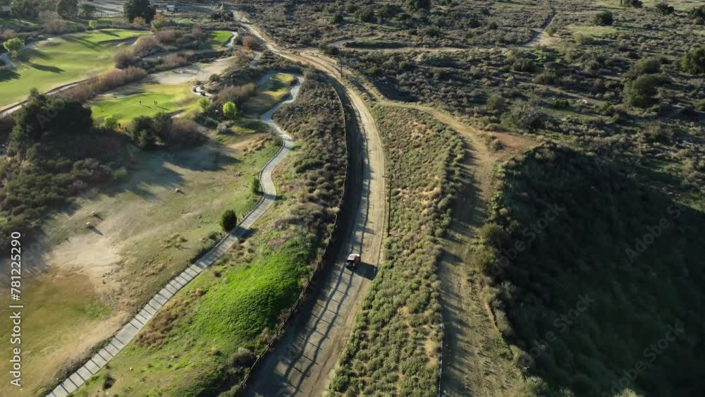 Aerial view of a a dirt road next to a golf course in Canyon Country, CA