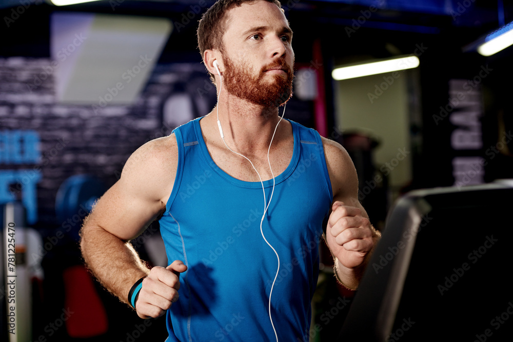 Fototapeta premium Earphones, exercise and man running on treadmill in gym for health, wellness and body weightloss. Fitness, runner and male athlete with cardio workout on machine for race training in sports center.