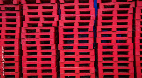 Red pallets arranged in layers © Kongkairt