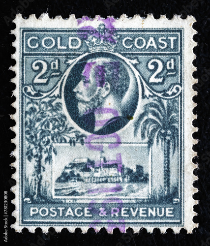 Ukraine, Kiyiv - February 3, 2024.Postage stamps from GOLD COAST.A stamp printed in Gold Coast shows King Ggeorge V & Christiansborg Castle, circa 1928.Philately.