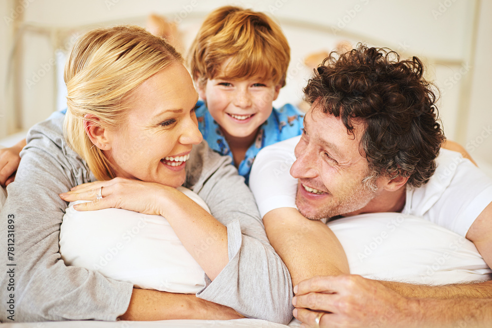 Family, child and home on bed for love, embrace and bonding by having fun in the morning with pyjamas. Happy, mom and dad with kid hugging in bedroom for positive childhood memories as unity Family, child and home on bed for love, embrace and bonding by having fun in the morning with pyjamas. Happy, mom and dad with kid hugging in bedroom for positive childhood memories as unity
