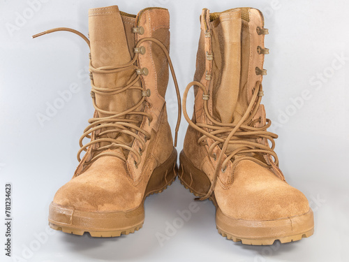 Pair of beige leather summer combat boots on gray background © An-T