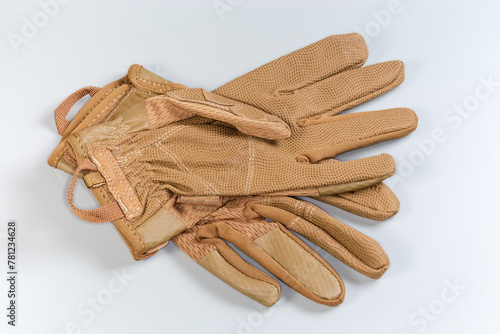 Beige tactical military gloves on a gray background © An-T