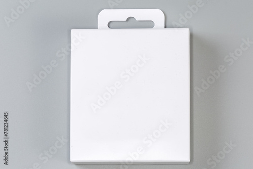 White rectangular cardboard hang tab packing box on gray surface © An-T