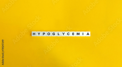 Hypoglycemia Word. Low Blood Sugar Concept. Text on Block Letter Tiles on Yellow Background. Minimalist Aesthetics. photo
