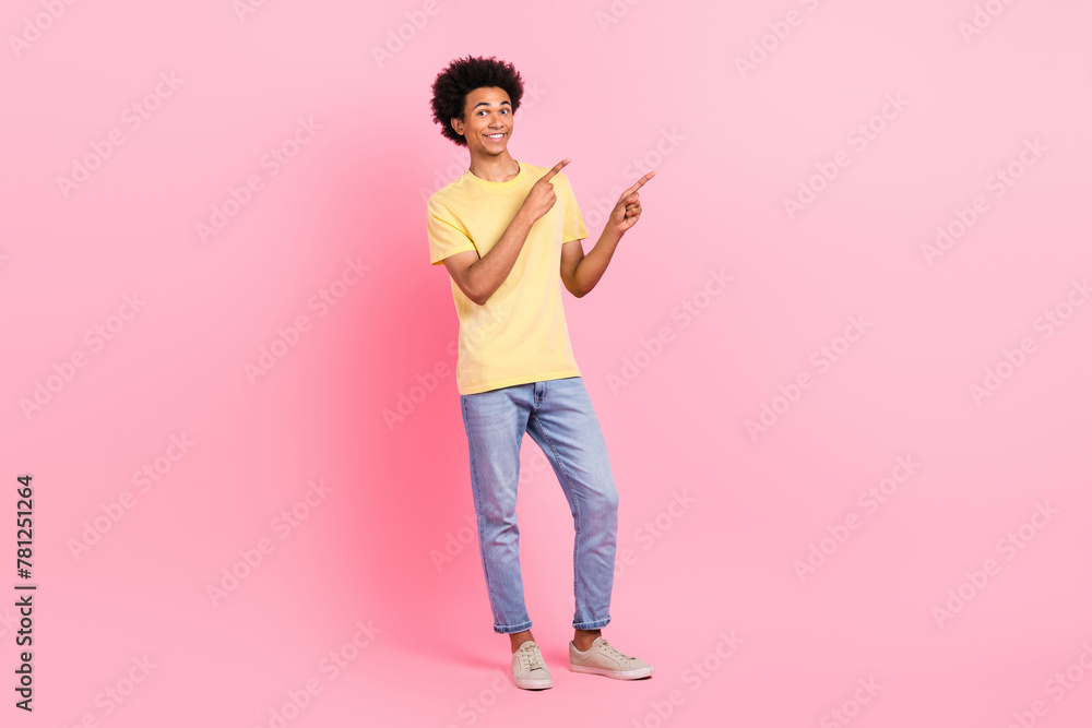 Full body portrait of nice young person indicate fingers empty space isolated on pink color background Full body portrait of nice young person indicate fingers empty space isolated on pink color background