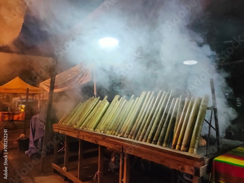 Malaysia's Lemang, a seasonal delight, blends glutinous rice, and coconut milk, roasted in bamboo tube lined with banana leaves. A cherished tradition sold by street hawkers. photo