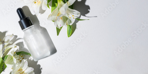 Serene beauty serum with fresh white flowers photo