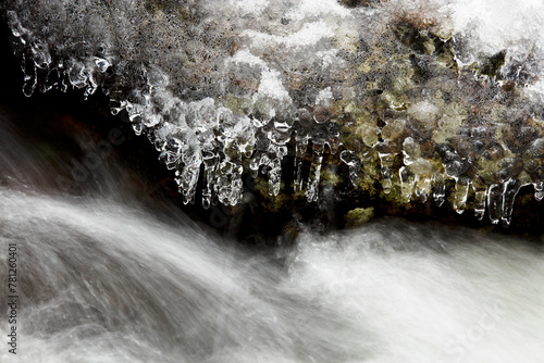 Frozen River Edge with Icicles in a Mountain Landscape photo