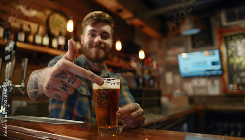 A man holds a glass of beer in a pub