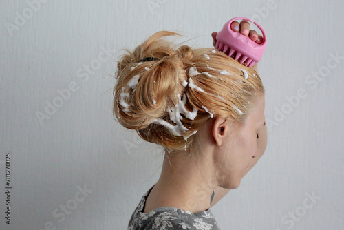 Woman using pink scalp massager for hair growth stimulating. Hair care pink silicone head massager.