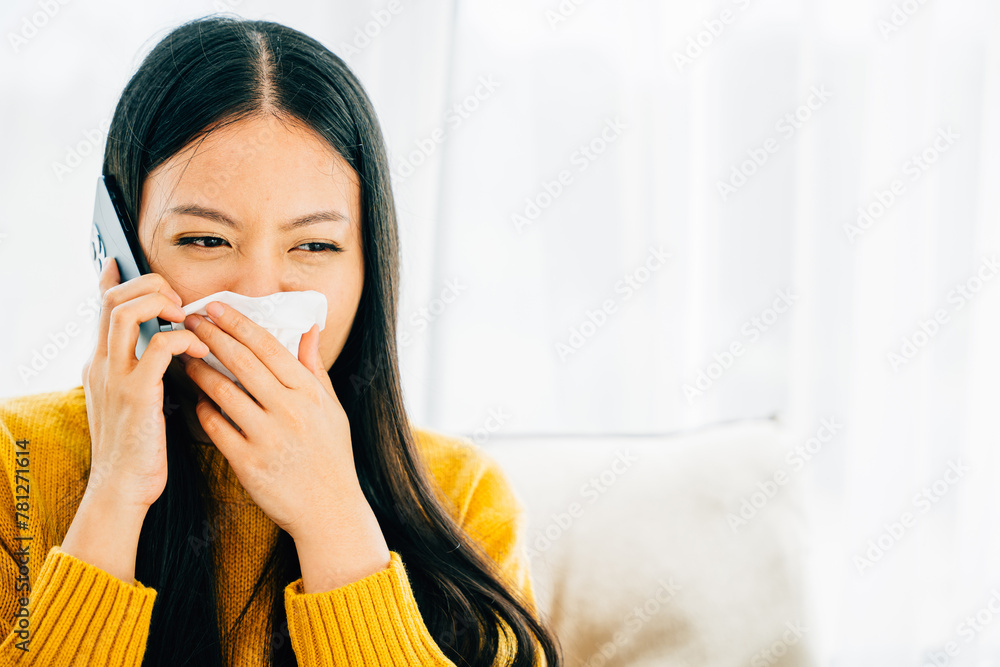 Amidst blowing wiping nose sneezing on sofa a sick female contacts doctor. An ill young girl discusses influenza symptoms with practitioner via phone seeking medicine. Conveying patient care at home. Amidst blowing wiping nose sneezing on sofa a sick female contacts doctor. An ill young girl discusses influenza symptoms with practitioner via phone seeking medicine. Conveying patient care at home.