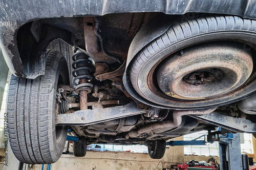Replacing brake pads and discs in a car on a lift at a service center