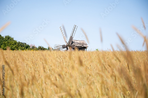 Wind mill. Windmill in a rural area. Wind Farm. Dutch windmill. Landscape with traditional Ukrainian windmills houses in countryside village. Windmill mill at rural outdoor. Rural skyline
